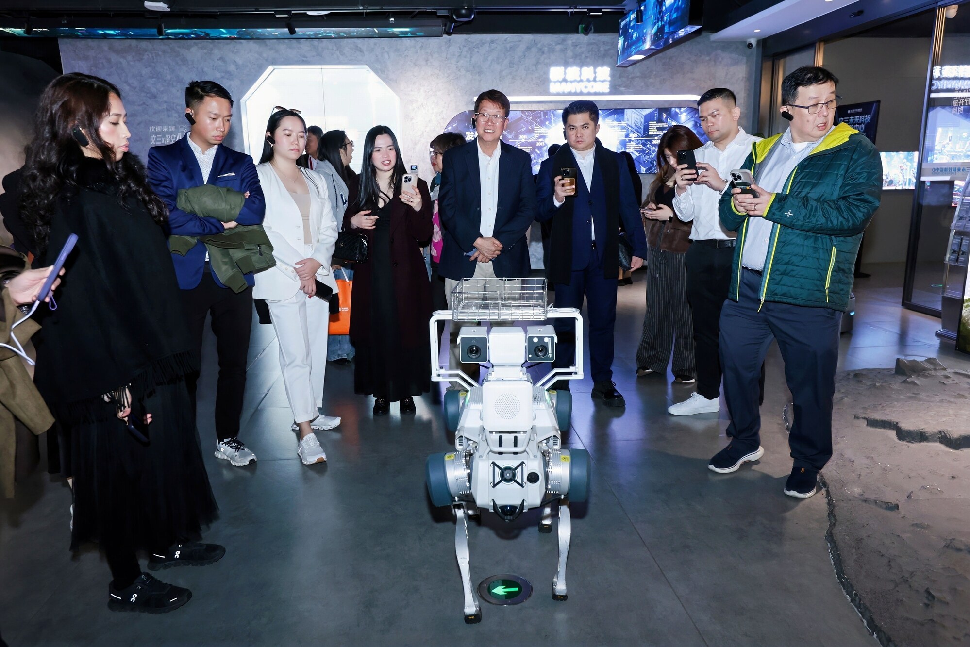 Participants interacting with a quadruped robot during the Hangzhou Robotics and AI Youth Immersion