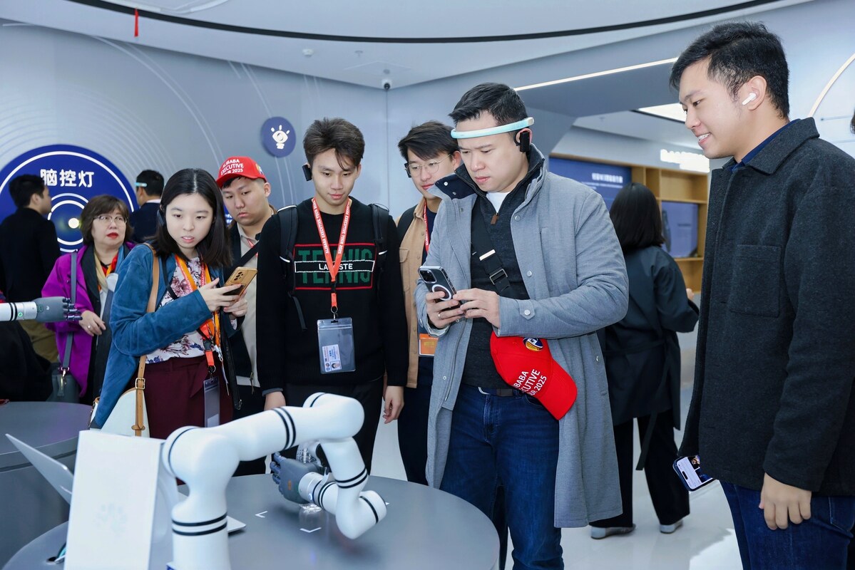 Programme participants observing an interactive robotics demonstration